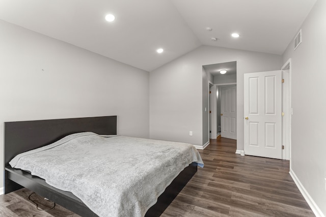 bedroom with visible vents, baseboards, lofted ceiling, and dark wood-style flooring