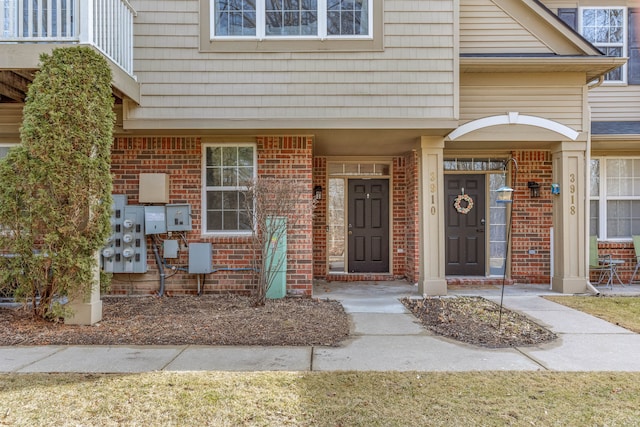 doorway to property with brick siding