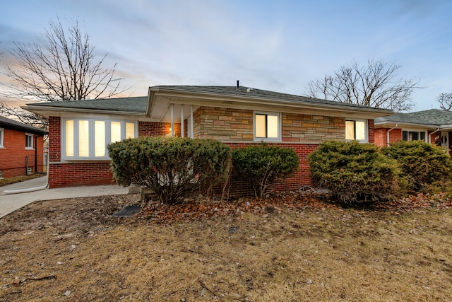 view of front of home with brick siding and stone siding