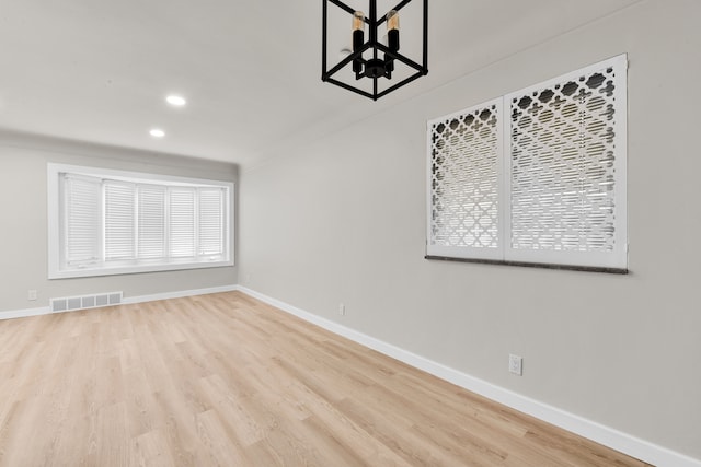 empty room featuring visible vents, recessed lighting, baseboards, and wood finished floors