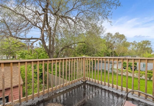 wooden terrace with a lawn