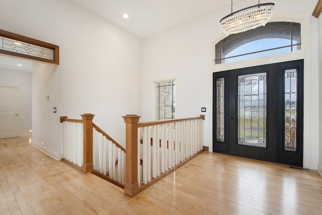 foyer featuring a wealth of natural light, wood-type flooring, and recessed lighting