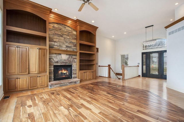 unfurnished living room featuring recessed lighting, light wood-style flooring, visible vents, and a stone fireplace