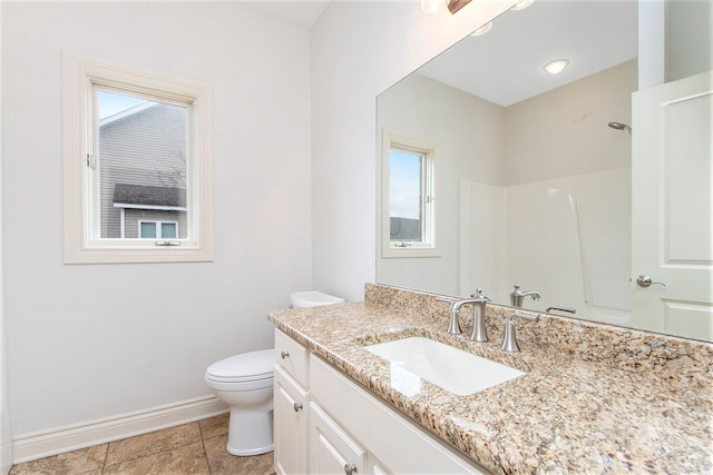 full bath with toilet, baseboards, a shower, and vanity