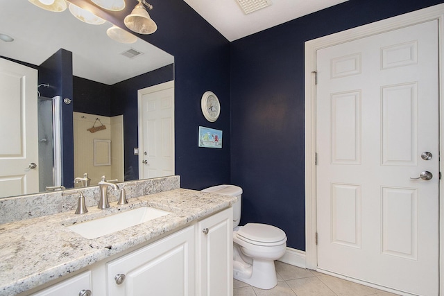 bathroom with toilet, tile patterned flooring, visible vents, and vanity