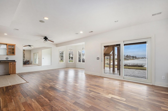 unfurnished living room with light wood-type flooring, visible vents, and recessed lighting