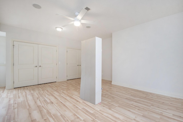 unfurnished room with a ceiling fan, baseboards, and light wood finished floors