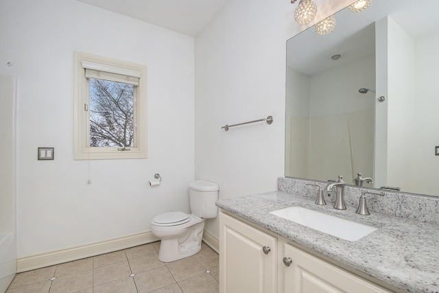 bathroom featuring tile patterned flooring, baseboards, vanity, and toilet