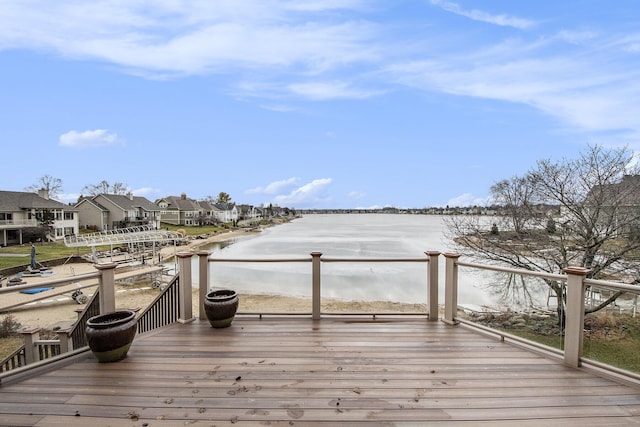 wooden deck featuring a residential view and a water view