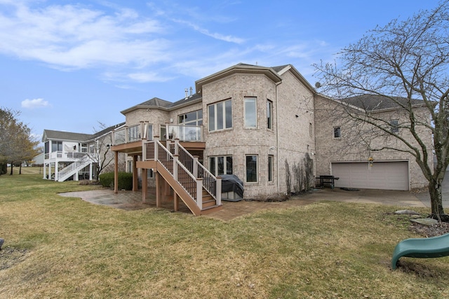 rear view of house featuring brick siding, stairway, a deck, and a yard