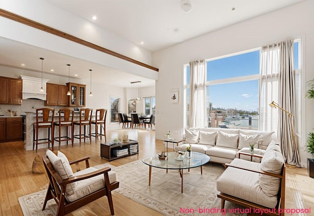 living area with recessed lighting and light wood-style floors