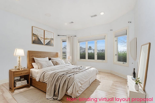 bedroom featuring visible vents, light wood-style flooring, and baseboards