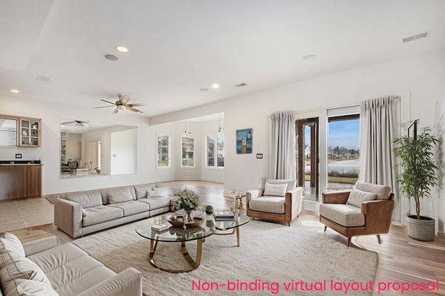 living room with light wood-style floors, recessed lighting, visible vents, and a ceiling fan