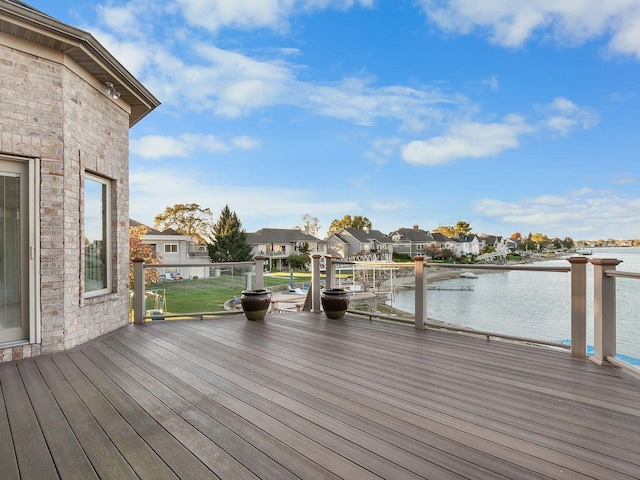 deck with a yard, a water view, and a residential view