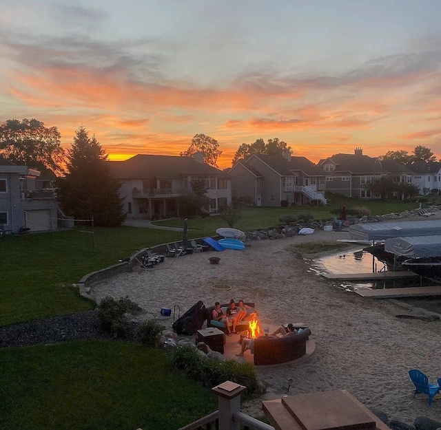 view of yard with an outdoor fire pit and a residential view