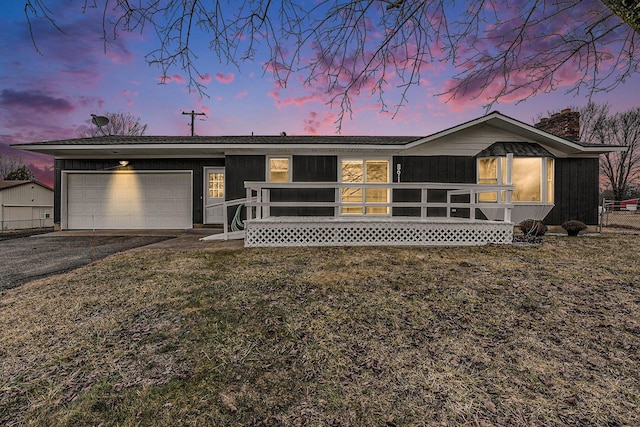 view of front of house with an attached garage and aphalt driveway