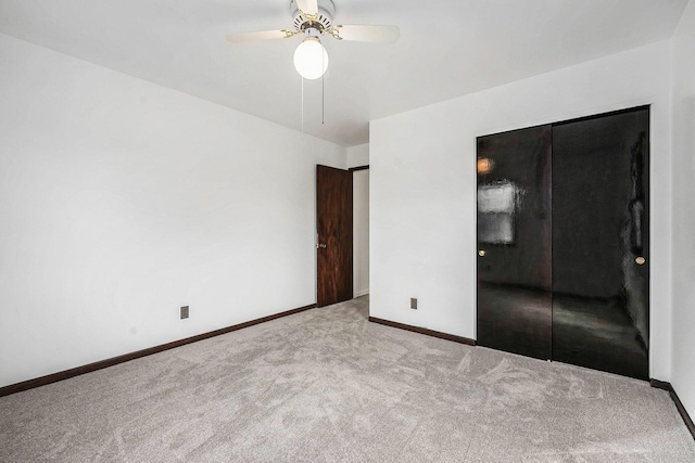 unfurnished bedroom with ceiling fan, baseboards, and carpet