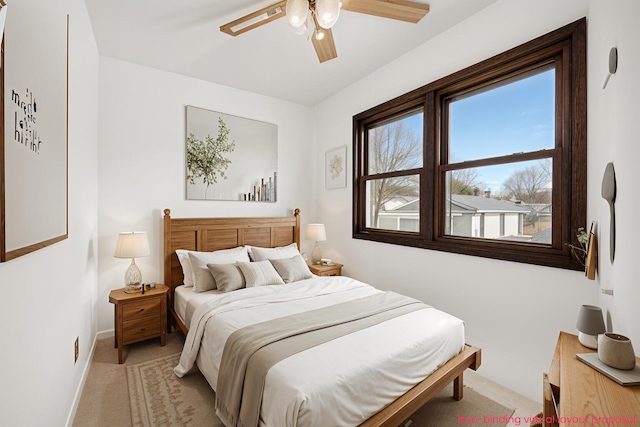 bedroom with baseboards, light colored carpet, and a ceiling fan