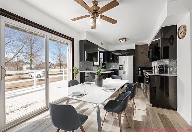 dining room featuring a ceiling fan and light wood finished floors