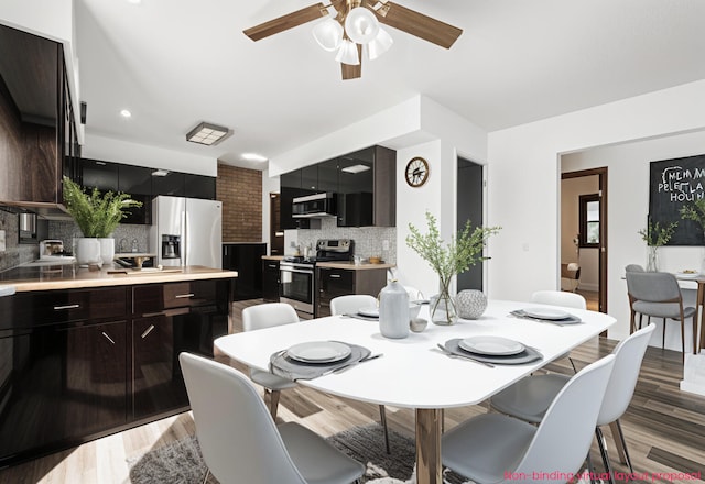 dining room with light wood-type flooring and ceiling fan