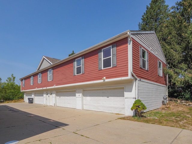 exterior space with a garage and concrete driveway