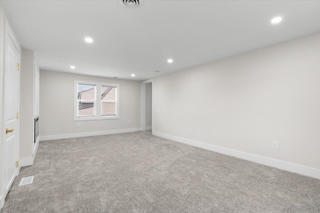 empty room with light carpet, baseboards, visible vents, and recessed lighting