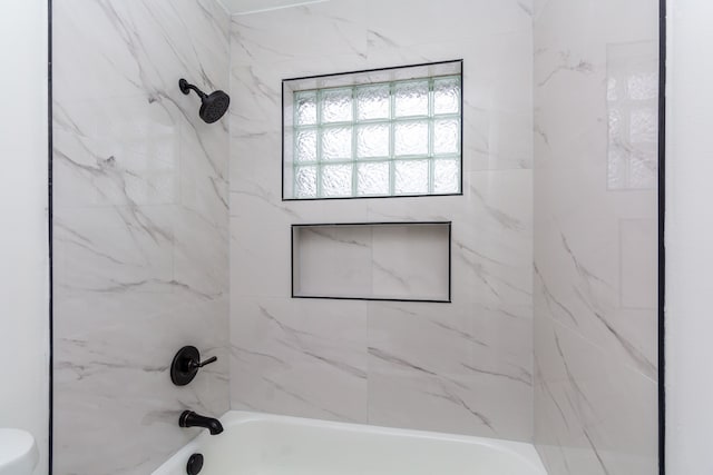 full bathroom featuring toilet and washtub / shower combination