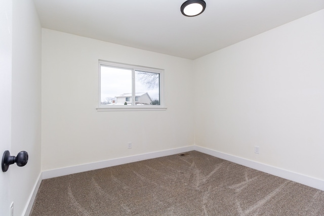 carpeted empty room with baseboards