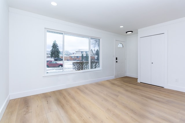 unfurnished room with light wood-style flooring, baseboards, and recessed lighting