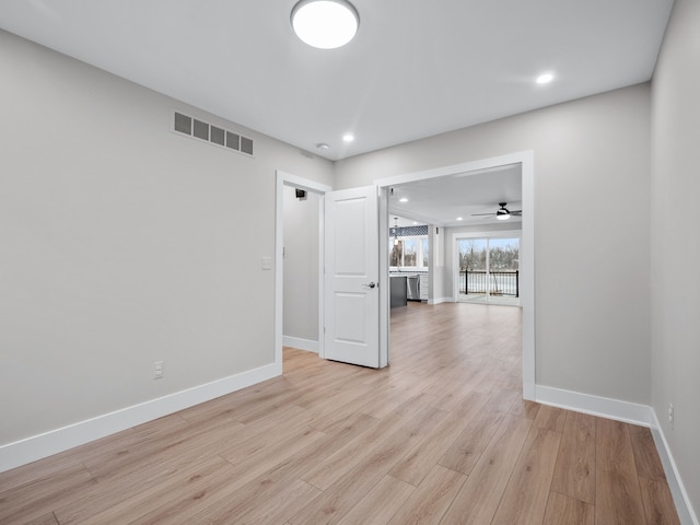 empty room with light wood finished floors, baseboards, visible vents, and recessed lighting