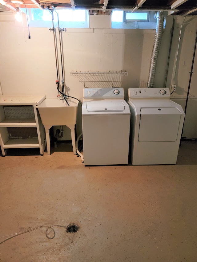 washroom featuring laundry area, independent washer and dryer, and a sink