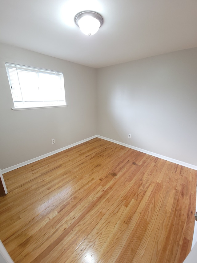 empty room featuring light wood-style floors and baseboards