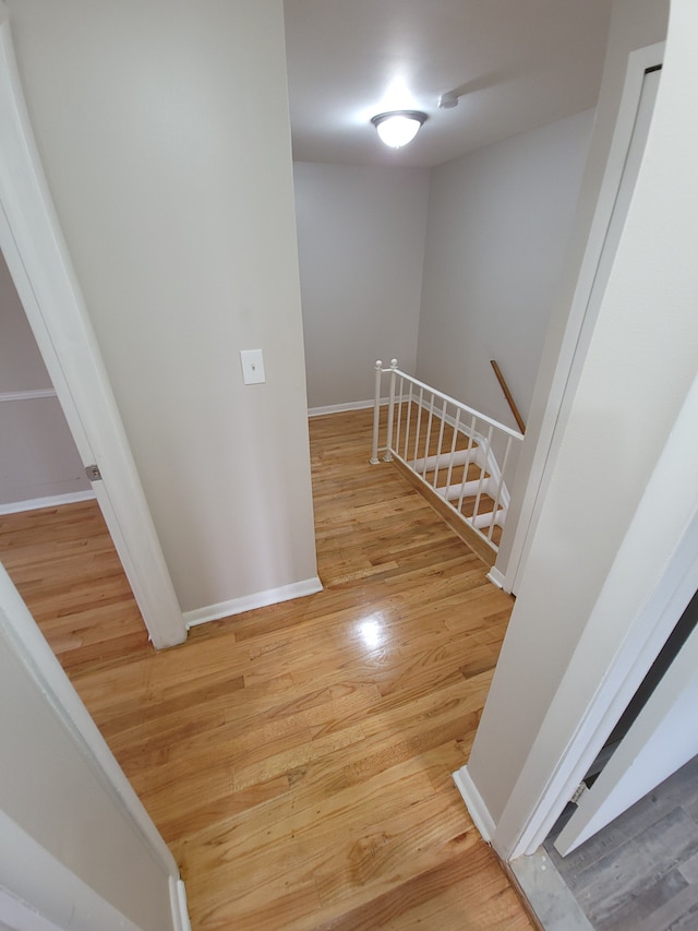 staircase with wood finished floors and baseboards