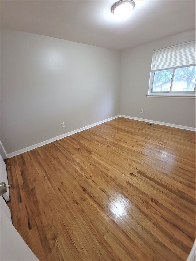 empty room featuring light wood-style floors and baseboards