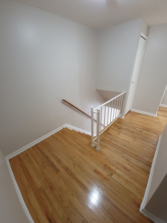 stairs featuring baseboards and wood finished floors