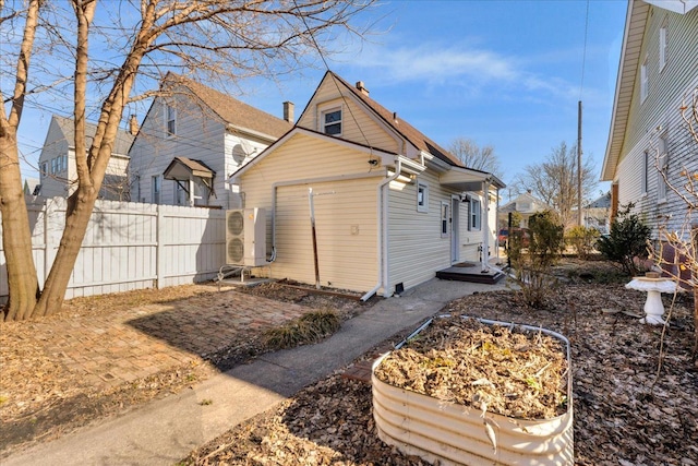 back of property with ac unit and fence