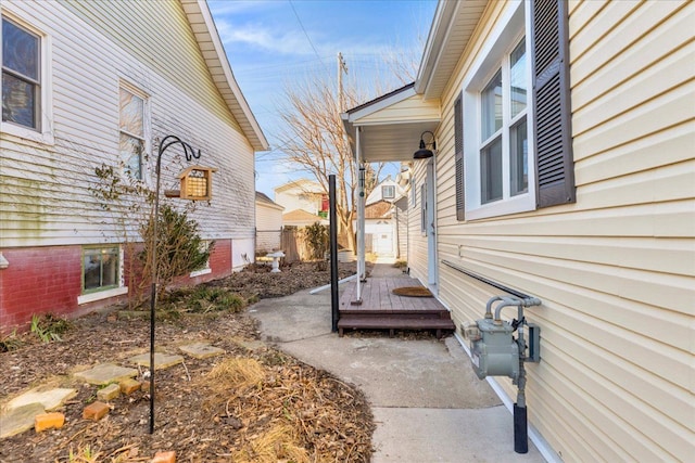 view of property exterior with a deck and fence