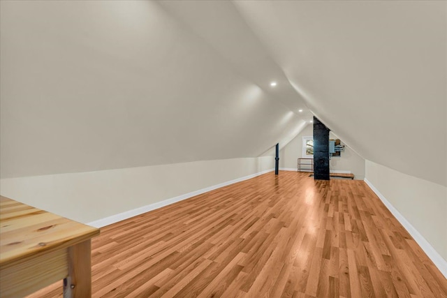 bonus room featuring recessed lighting, baseboards, lofted ceiling, and light wood-style flooring