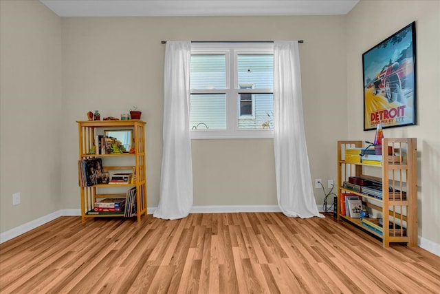 miscellaneous room featuring baseboards and light wood finished floors