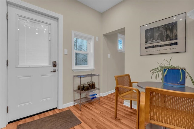 entrance foyer with baseboards and light wood-style floors