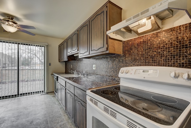 kitchen featuring dark countertops, white range with electric cooktop, under cabinet range hood, dark brown cabinetry, and decorative backsplash