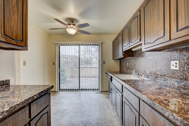 kitchen with a sink, backsplash, dark brown cabinetry, and ceiling fan