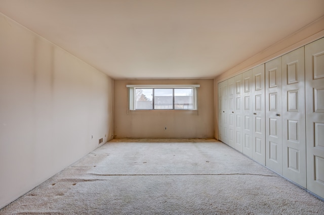 unfurnished bedroom featuring a closet and carpet flooring