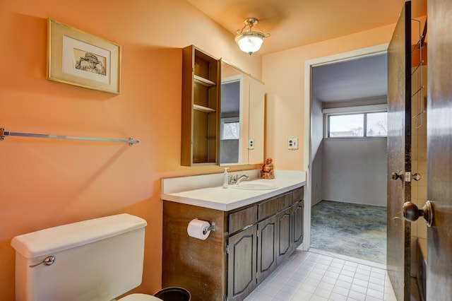 bathroom featuring tile patterned floors, toilet, and vanity