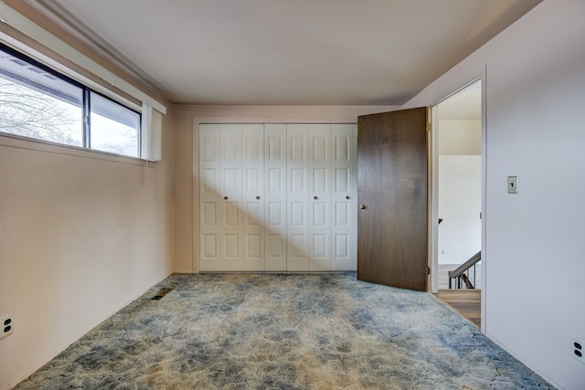 carpeted bedroom with a closet