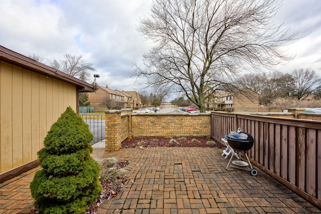 view of patio with area for grilling and fence