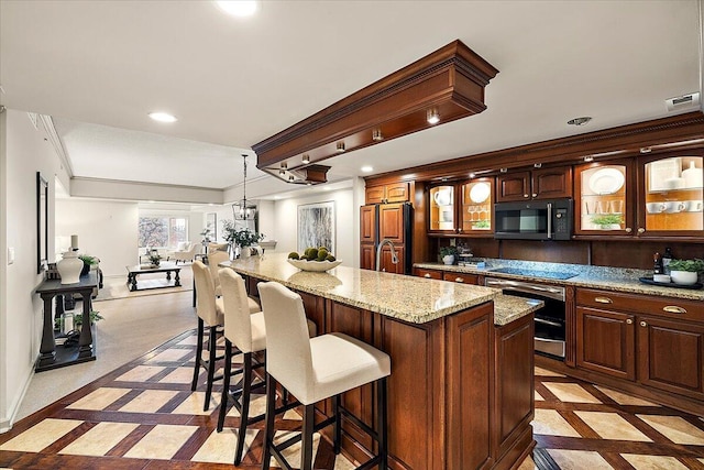 kitchen featuring black microwave, paneled fridge, recessed lighting, and crown molding