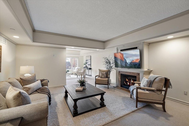 living room with ornamental molding, light colored carpet, a lit fireplace, and a textured ceiling