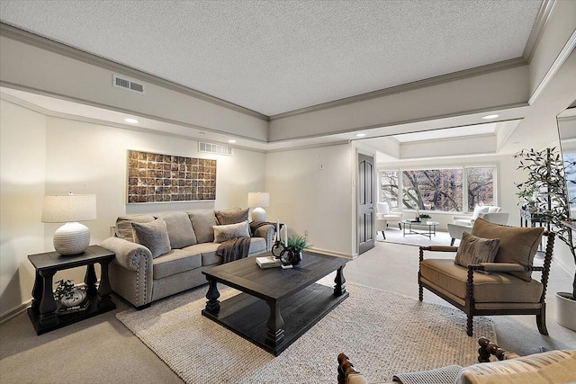 carpeted living room with visible vents, a textured ceiling, and ornamental molding