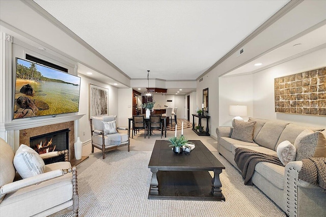 living area with crown molding, a high end fireplace, and light colored carpet